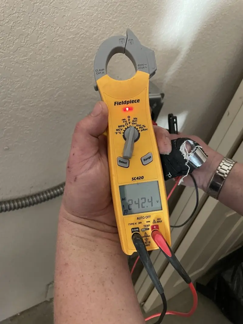 Voltage testing with clamp meter during Whole House Surge Protector in Ferris